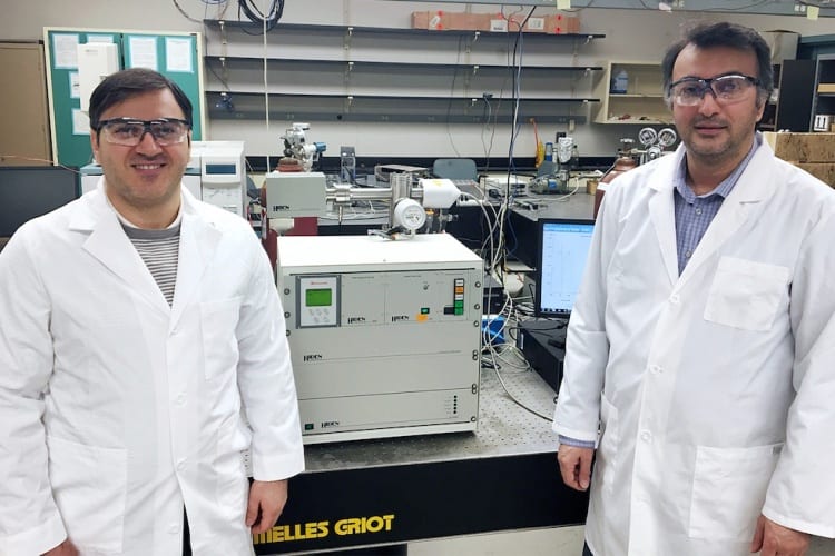 Amin Salehi-Khojin, assistant professor of mechanical and industrial engineering (right), and postdoctoral research associate Mohammad Asadi with their specially modified differential electrochemical mass spectrometry (DEMS) instrument. © UIC College of Engineering 