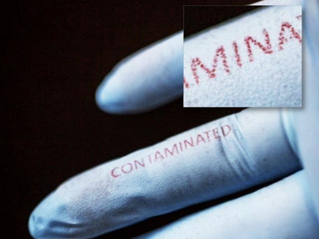 Silk inks doped with bacteria-sensing agents were printed on surgical gloves using inkjet technology. The word "contaminated" changed from blue to red after exposure to E. coli.