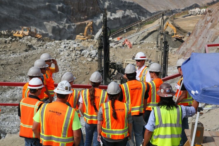 Construction and engineering students visiting a work site.