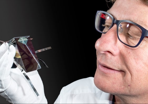 Dr Mark Keevers with one of the spectrum splitting, four-junction mini-modules (Credit: UNSW)