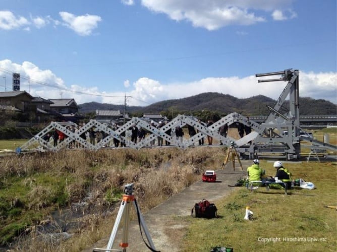 People walked on the completed MB over the Hongo river in Fukuyama City at its first construction test.