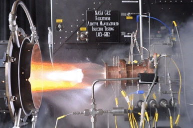 Liquid oxygen/gaseous hydrogen rocket injector assembly built using additive manufacturing technology is hot-fire tested at NASA Glenn Research Center’s Rocket Combustion Laboratory in Cleveland