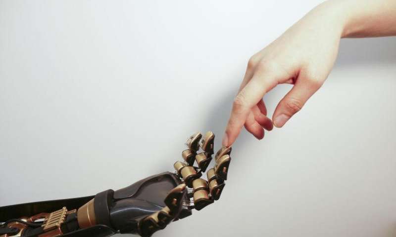 The transparent plastic and black device on the golden "fingertip" is the skin-like sensor developed by Stanford engineers. This sensor can detect pressure and transmit that touch sensation to a nerve cell.