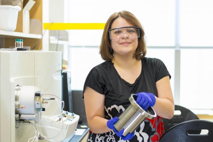 Marion Emmert, assistant professor of chemistry with the drive unit from an all-electric Chevrolet Spark vehicle. She has developed a chemical method for extracting rare earth elements from the unit's magnets.