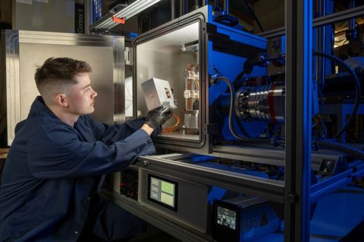 Matthew Deans of the James Watt School of Engineering loads a cartridge of 3D-printed material samples into the NextSpace TestRig for testing