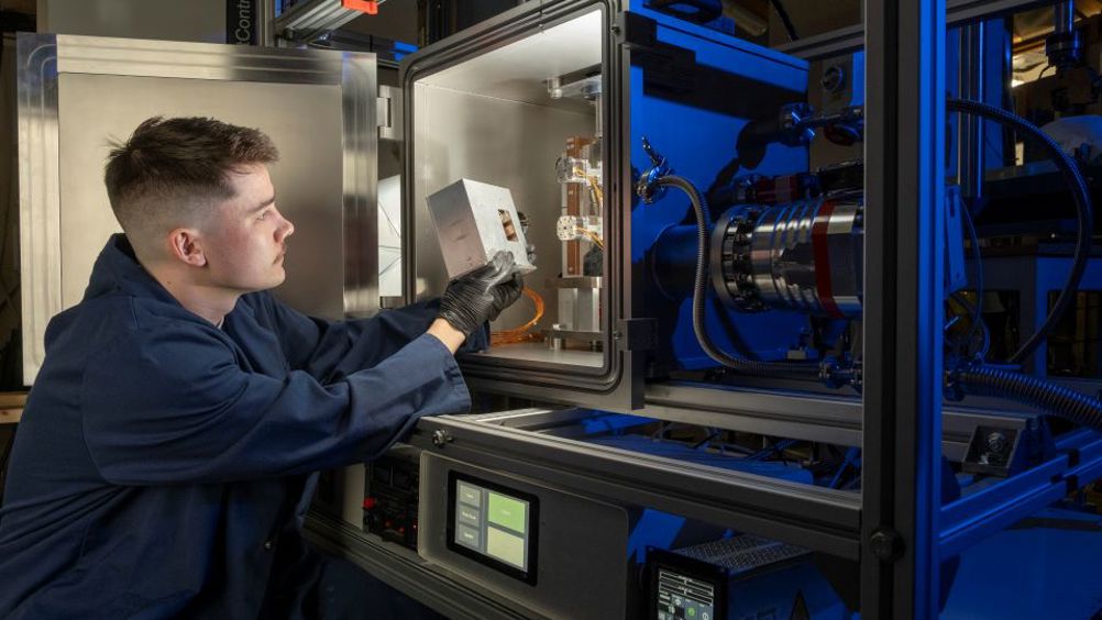 Matthew Deans of the James Watt School of Engineering loads a cartridge of 3D-printed material samples into the NextSpace TestRig for testing