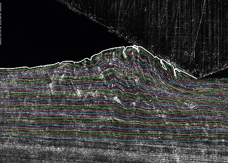 This frame from a high-speed camera sequence reveals surprising behavior in a solid piece of metal sliding over another. The research is providing new insights into the mechanisms of wear and generation of machined surfaces that could help improve the dur