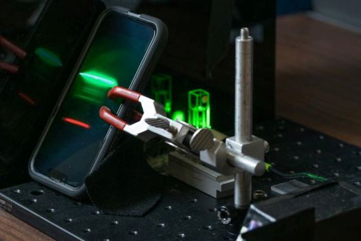 A smartphone records the Raman spectrum of an unknown material (an ethanol solution, in this case) for further analysis