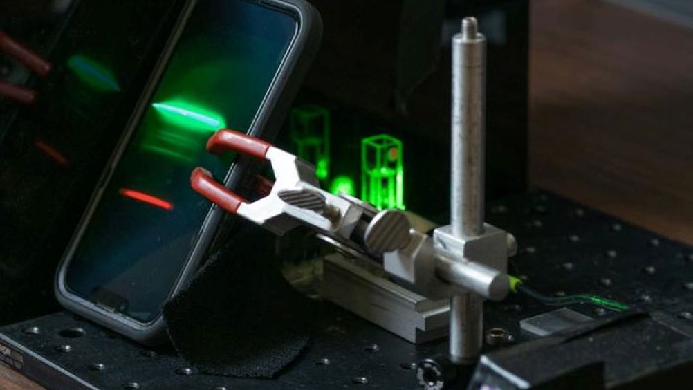 A smartphone records the Raman spectrum of an unknown material (an ethanol solution, in this case) for further analysis