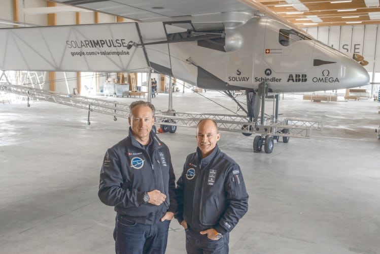 André Borschberg and Bertrand Piccard beside the cockpit of Solar Impulse 2