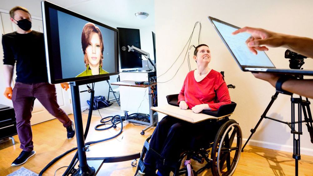 Ann, a research participant in a study of speech neuroprostheses led by UCSF's Edward Chang, is connected to computers that translate her brain signals into the speech and facial movements of an avatar. At left is UCSF clinical research coordinator Max Dougherty