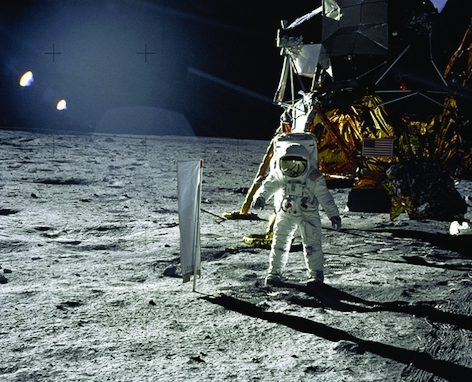 Astronaut Edwin E. Aldrin, Jr., lunar Module pilot, is photographed during the Apollo 11 extravehicular activity (EVA) on the lunar surface. In the right background is the Lunar Module "Eagle." On Aldrin's right is the Solar Wind Composition (SWC) experim