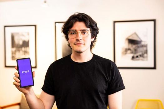 A team led by researchers at the University of Washington has created an app — FeverPhone — that transforms smartphones into thermometers without adding new hardware. Shown here is lead author Joseph Breda, a UW doctoral student in the Paul G. Allen School of Computer Science & Engineering