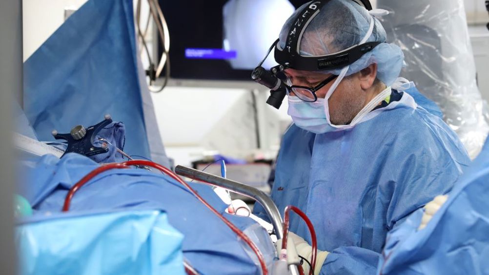 Dr. Ashesh Mehta implants five tiny computer chips into the brain of a man living with paralysis, key components of the novel ‘double neural bypass’ technology developed at Northwell Health’s Feinstein Institutes for Medical Research. This new technology is helping restore not only movement, but also sensation in the arm and hand of a paralysed person