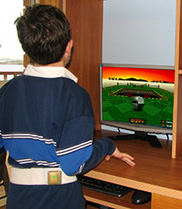 A child fitted with an accelerometer trials a computer game designed to encourage movement