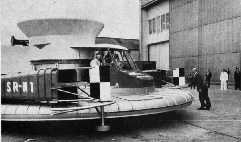 Christopher Cockerell, inventor of the hovercraft, pushing his prototype machine