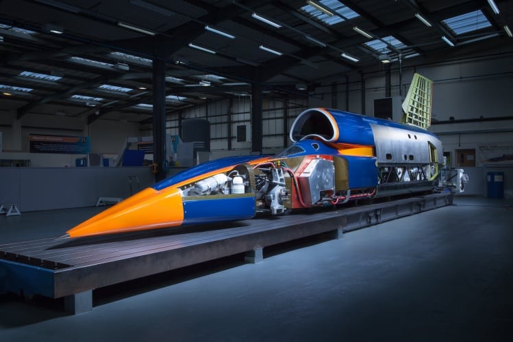 Carbon fibre panels have been partially removed on one side in order to show the technology inside the car, including the Rolls-Royce EJ200 jet engine and supercharged Jaguar V8 engine used to pump oxidizer into the Nammo rocket