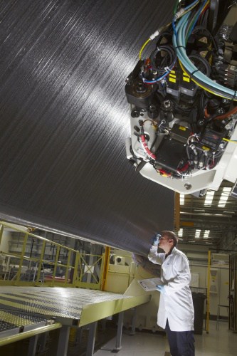 A GKN engineer inspects a composite wing spar