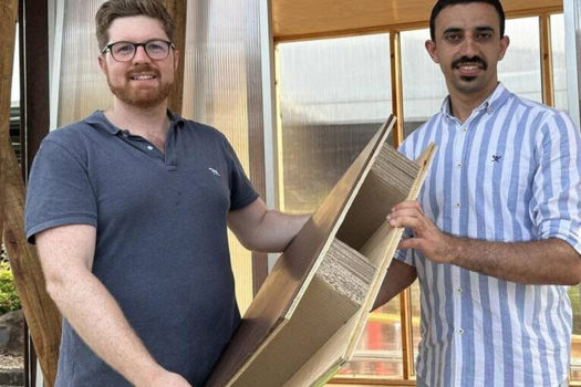 Associate Professor Joe Gattas (left) and PHD student Mahmoud Abu-Saleem with one of their timber-cardboard web-core sandwich (TCWS) panels