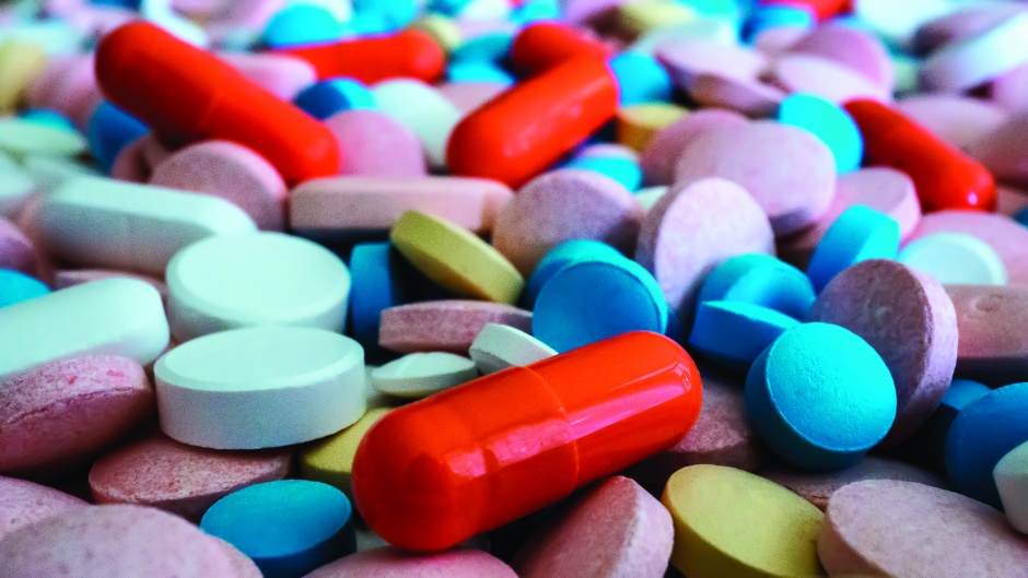 Heap of medicine pills. Close up of colorful tablets and capsules.