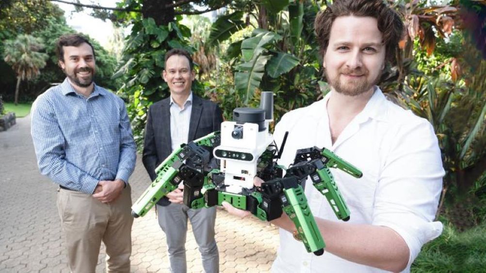 Dr Adam Hines, with his 'green' robot. l/r- Dr Tobias Fischer, Dr Adam Hines and Professor Michael Milford