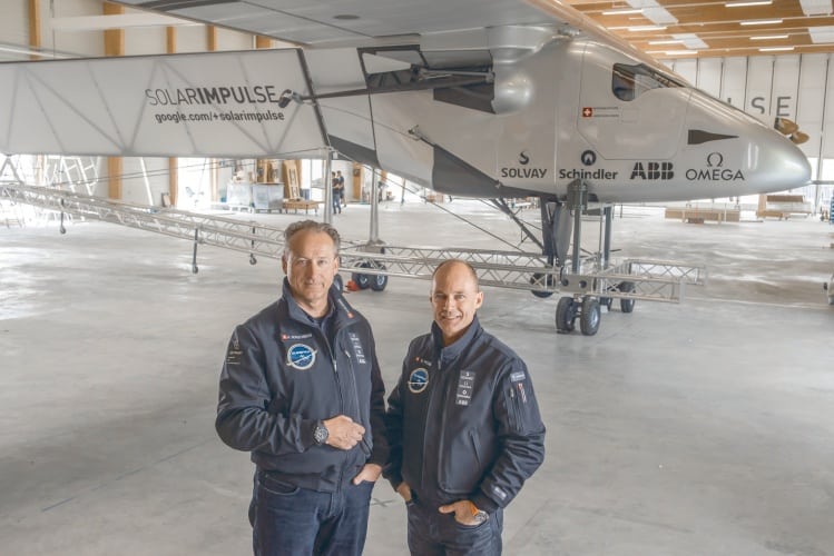 AndrâˆšÂ© Borschberg and Bertrand Piccard beside the cockpit of Solar Impulse 2