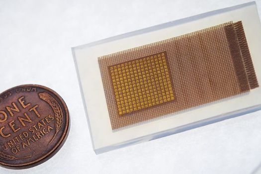 This soft and stretchy ultrasound patch can be worn on the temple to provide continuous monitoring of blood flow in the brain. During use, the patch is connected through cables to a power source and computer