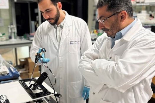 Wael Othman and Mohammad A. Qasaimeh with the off-the-jaw tactile feedback system
