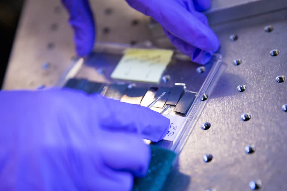 A SLAC scientist with samples to be tested in the Rapid Thermal Processing instrument at the lab’s Stanford Synchrotron Radiation Lightsource. (SLAC National Accelerator Laboratory)