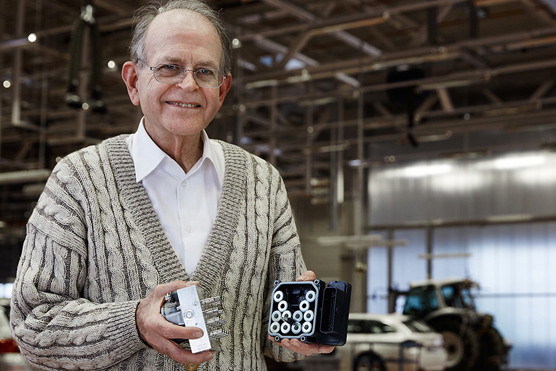 Anton van Zanten holds an example of the ESC unit he's credited with inventing.