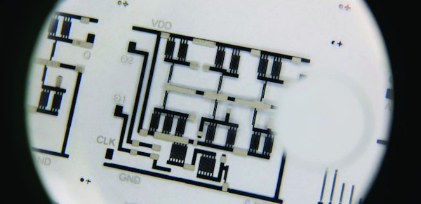 A low-cost complex electronic circuit printed on a transparent plastic sheet