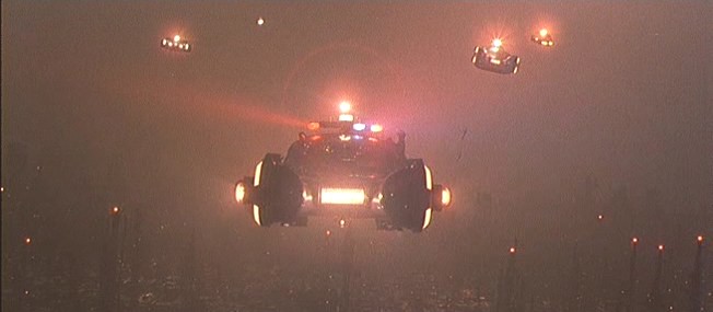 Flying cars loom through the city smog in Blade Runner