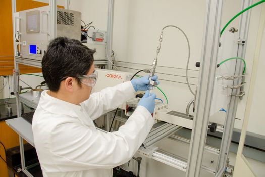WVU researcher Yuxin Wang loads polypropylene into a microwave reactor