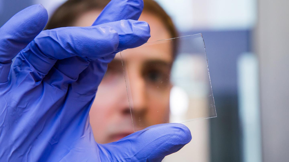 Nicholas Davy holds a sample of the special window glass