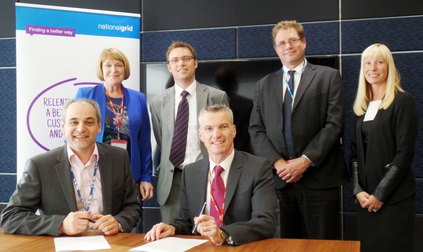 Representatives from the University of Warwick and National Grid sign the MoU.