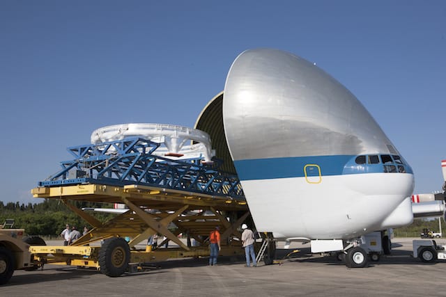 The Orion spacecraft service module stacking assembly interface ring and stack holding stand are secured on a special transportation platform and are being loaded into NASA's Super Guppy aircraft at the Shuttle Landing Facility at NASA's Kennedy Space Cen