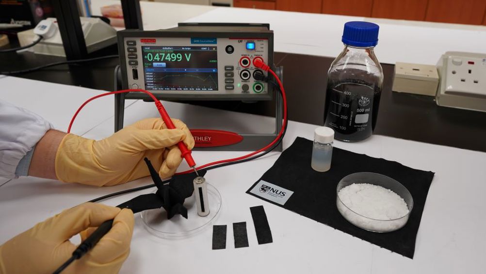 The new moisture-driven MEG device invented by researchers from the National University of Singapore can withstand twisting, rolling and bending. A small piece of the MEG device can generate up to 0.7V of electricity for over 150 hours