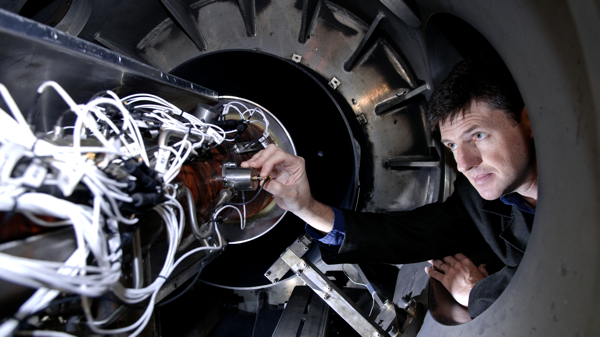 SCRAMSPACE project lead Prof Boyce with the prototype engine in the shock tunnel
