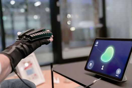 Bioliberty's glove tunes in to muscle activity and predicts the 3D position of the user's hand